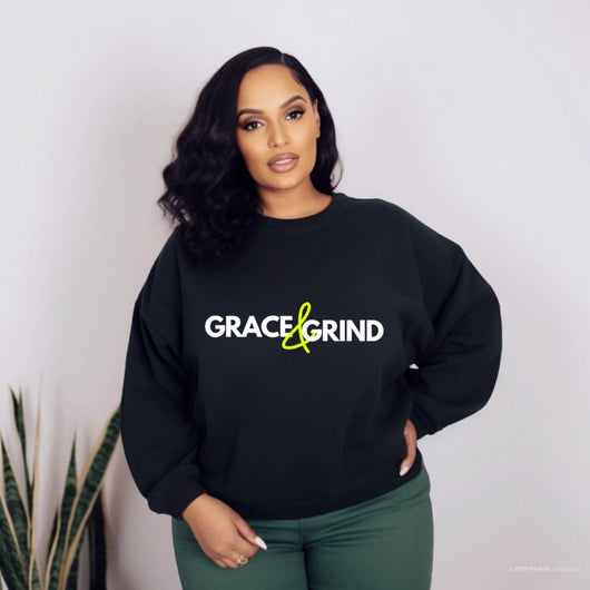 woman wearing a black sweatshirt with words grace & grind in green and white
