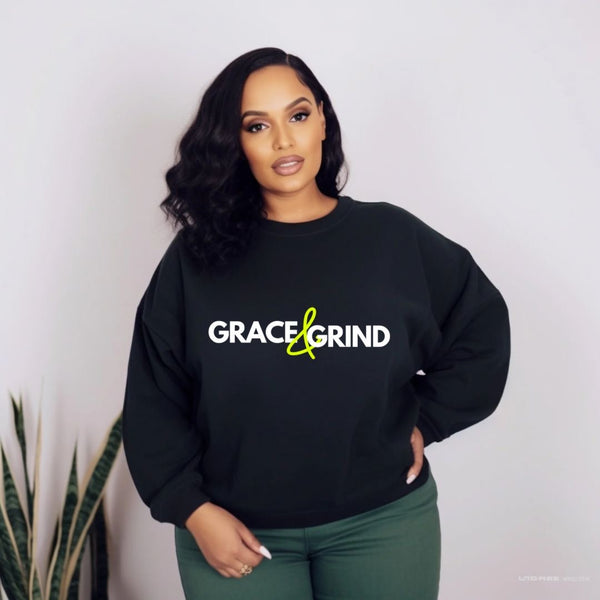 woman wearing a black sweatshirt with words grace & grind in green and white