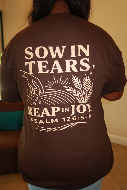 a brown shirt with a design written sow in tears 