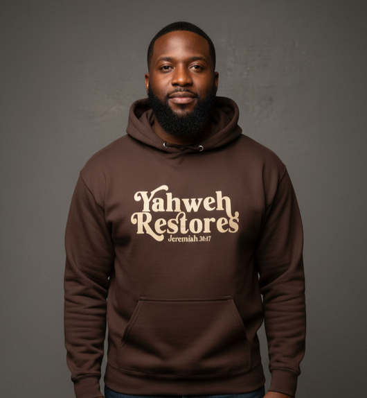 Person wearing a brown hoodie with 'Vahweh Restores' text on a gray background